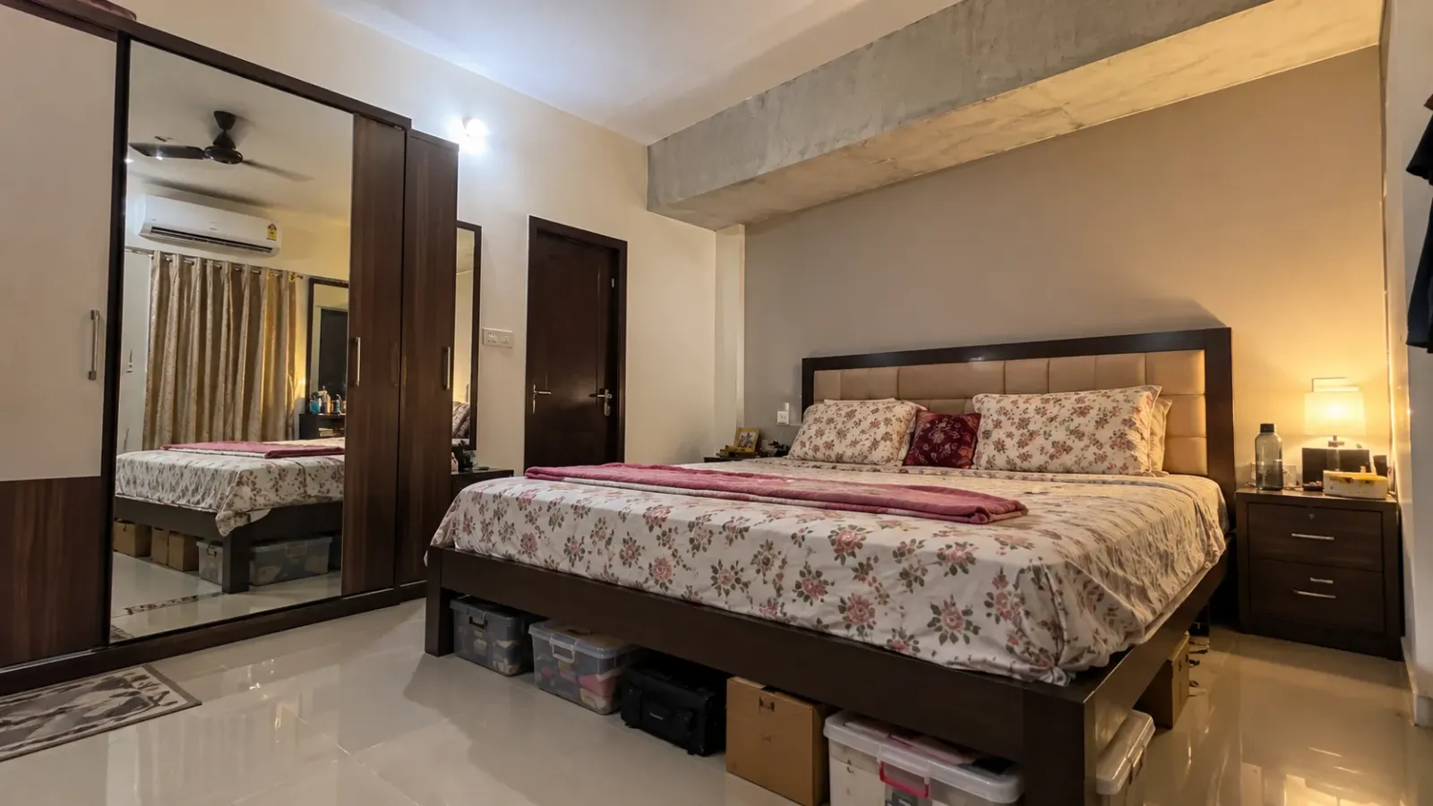 Couple bedroom Vastu mistakes — mirror facing the bed, a beam over the headboard and clutter under the bed